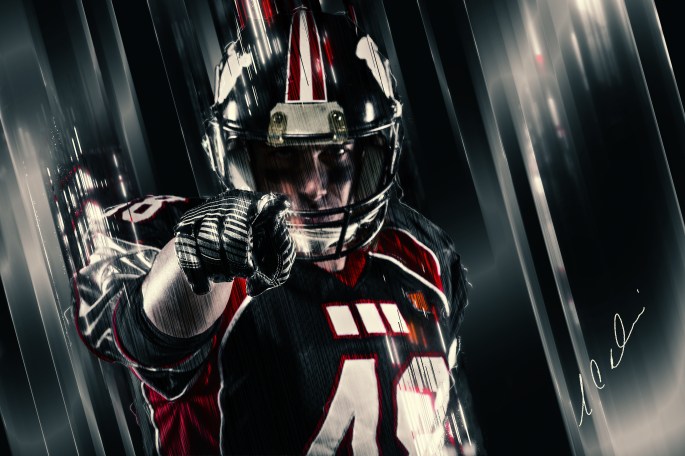 Portrait of american football player pointing at you.